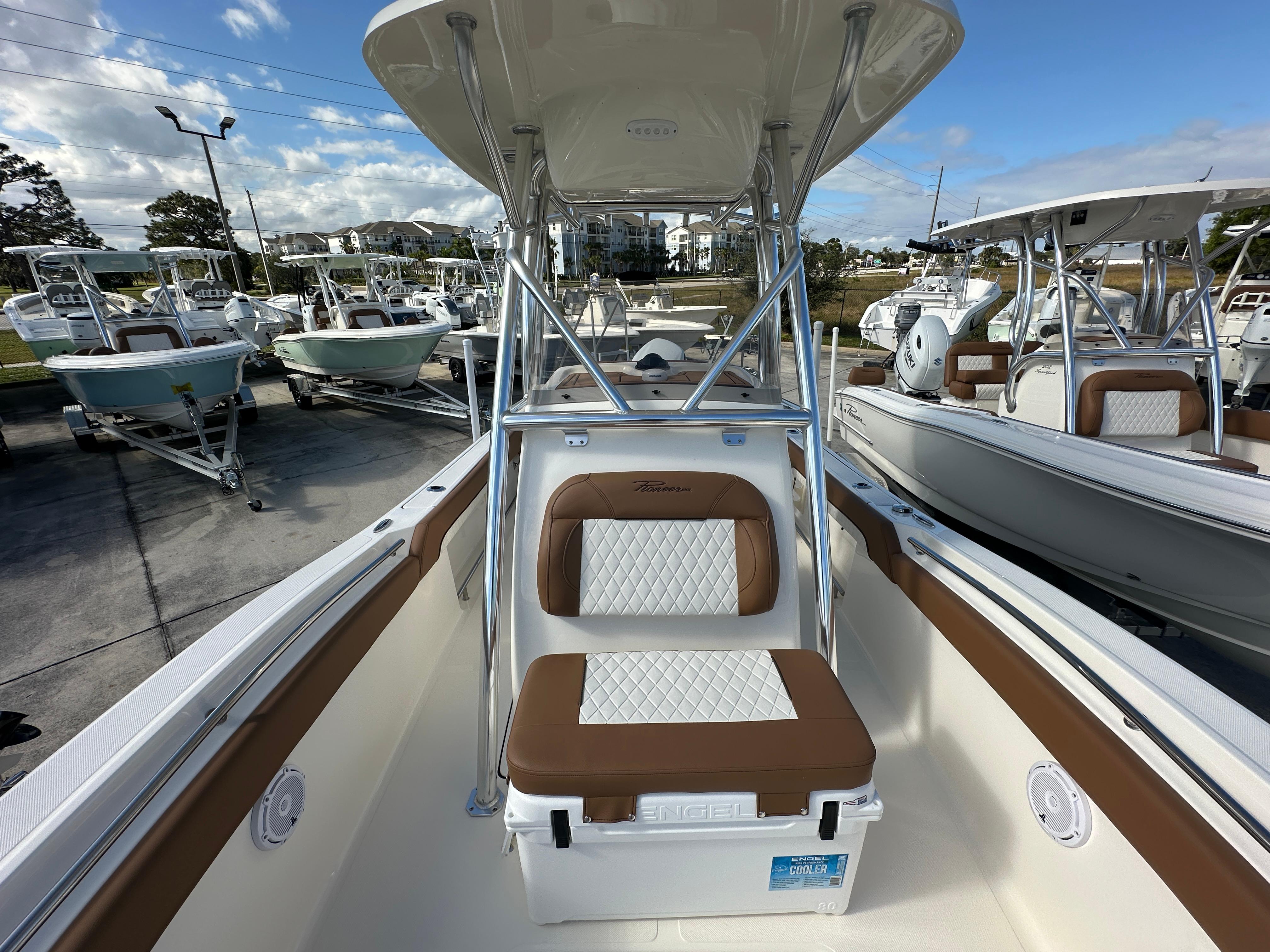 2025 Pioneer 222 Sportfish boat interior with cushioned seating and T-top.