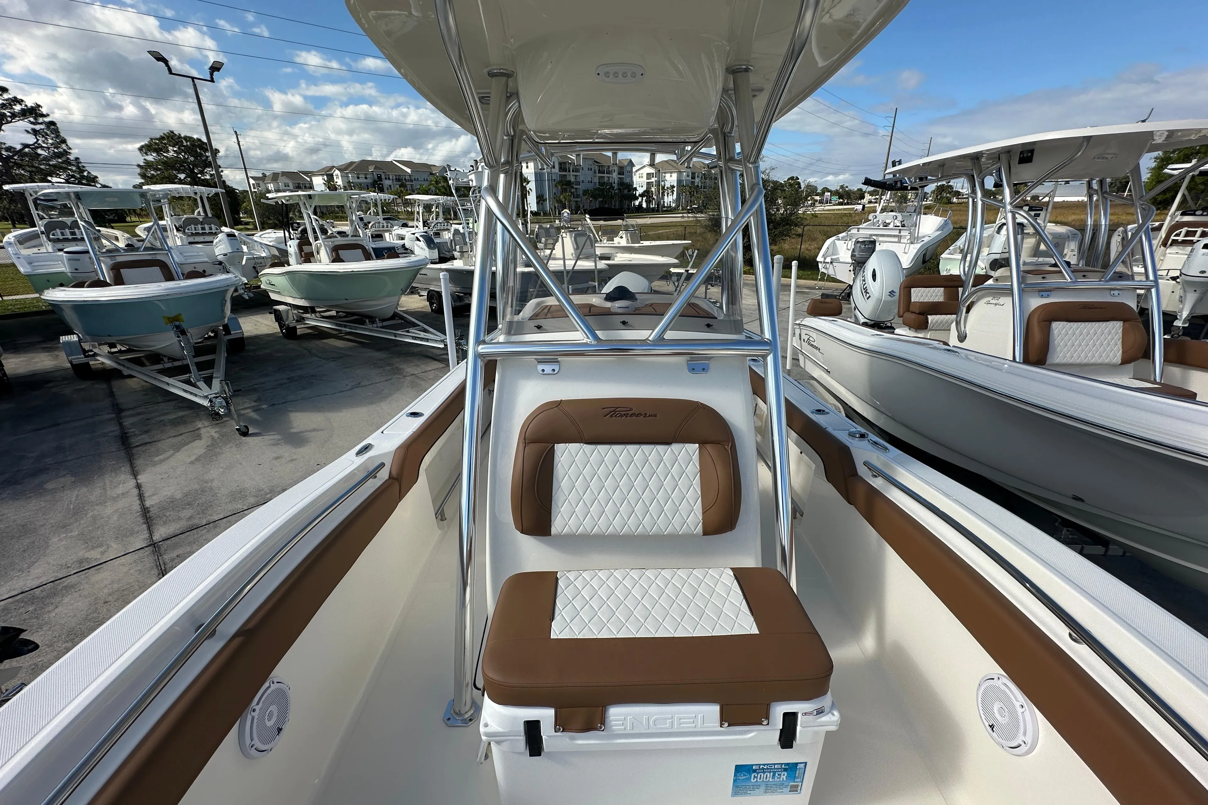 2025 Pioneer 222 Sportfish boat interior with cushioned seating and T-top.