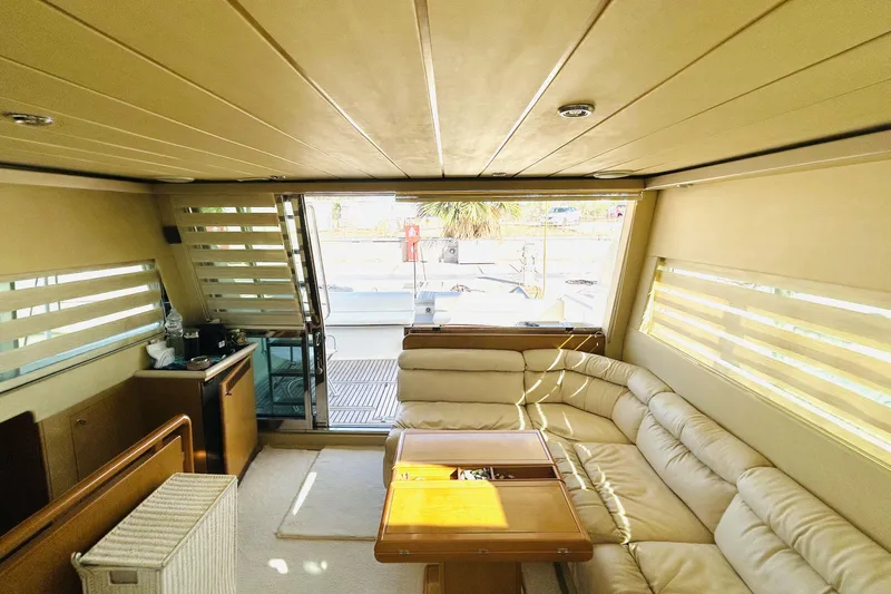  Yacht Photos Pics Luxurious interior of 1992 Ferretti Yachts 45 Altura with beige seating and wooden accents.