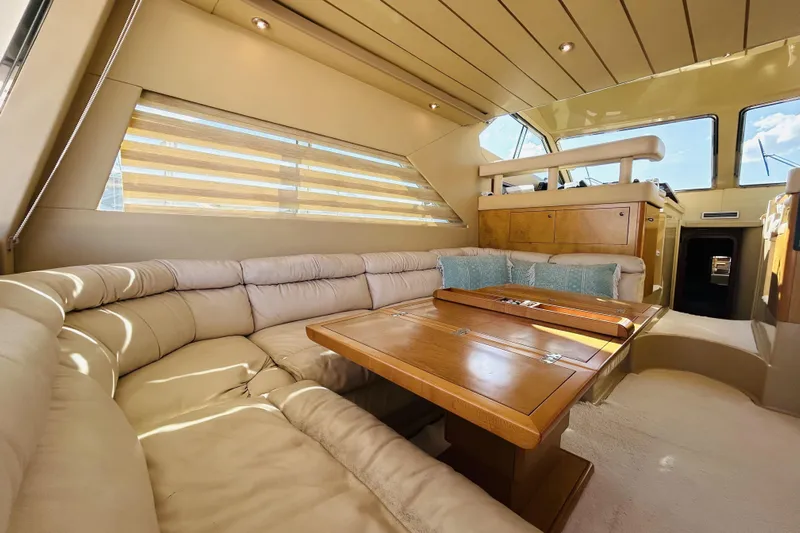  Yacht Photos Pics Luxurious interior of 1992 Ferretti Yachts 45 Altura with plush seating and wooden table.