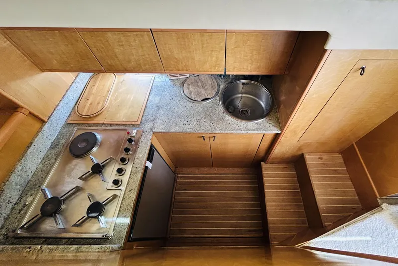  Yacht Photos Pics Compact kitchen area in a 1992 Ferretti Yachts 45 Altura, featuring stove and sink.