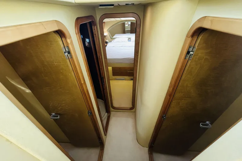 Yacht Photos Pics Interior hallway of 1992 Ferretti Yachts 45 Altura, featuring wooden doors and cozy design.