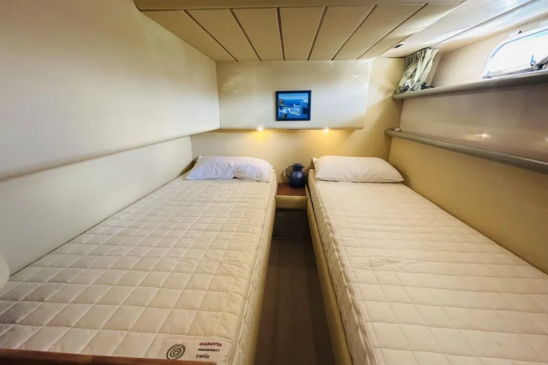  Yacht Photos Pics Twin cabin interior of 1992 Ferretti Yachts 45 Altura, featuring cozy beds and soft lighting.