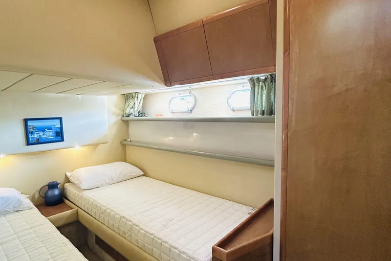  Yacht Photos Pics Interior cabin of 1992 Ferretti Yachts 45 Altura with twin beds and nautical decor.