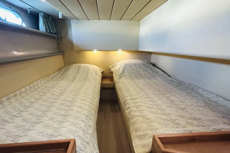  Yacht Photos Pics Twin beds in a cozy cabin of a 1992 Ferretti Yachts 45 Altura.