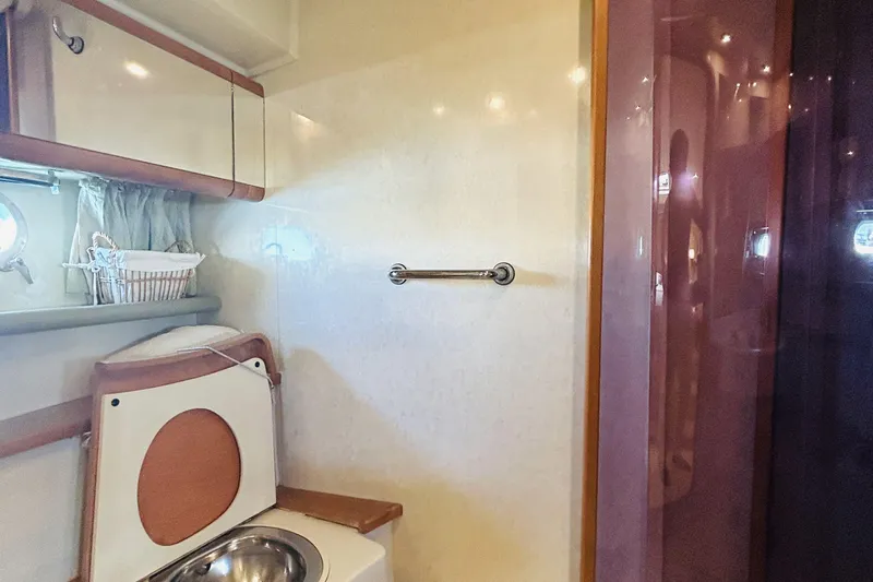  Yacht Photos Pics Interior of 1992 Ferretti Yachts 45 Altura bathroom with sink and storage.