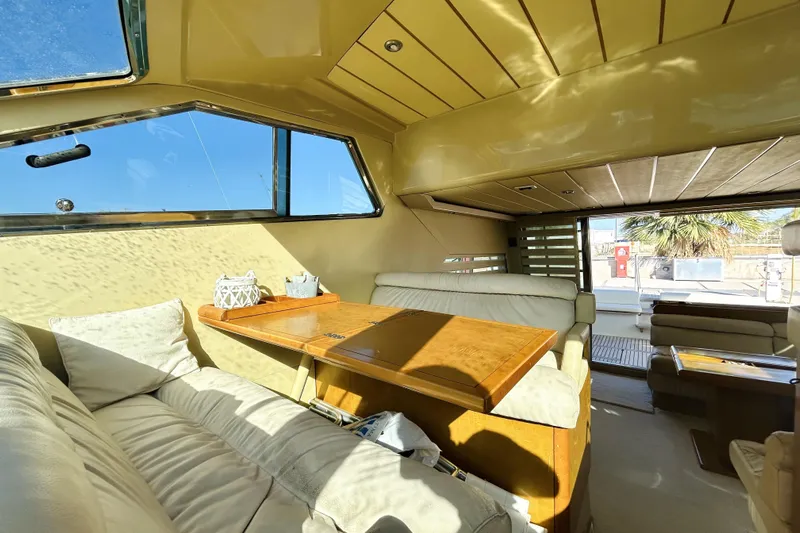  Yacht Photos Pics Luxurious interior of 1992 Ferretti Yachts 45 Altura with plush seating and wooden table.