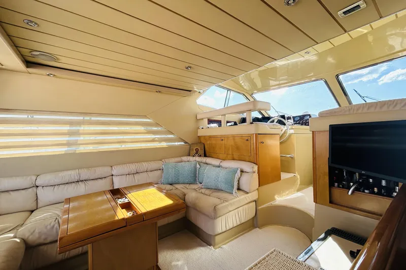  Yacht Photos Pics Luxurious interior of 1992 Ferretti Yachts 45 Altura with plush seating and elegant wood finishes.