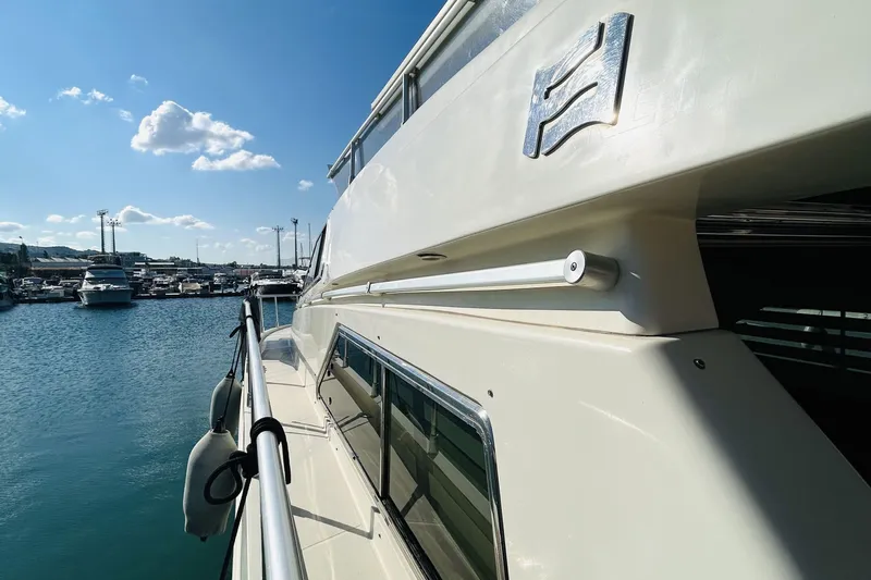  Yacht Photos Pics 1992 Ferretti Yachts 45 Altura docked in a sunny marina, showcasing sleek design.