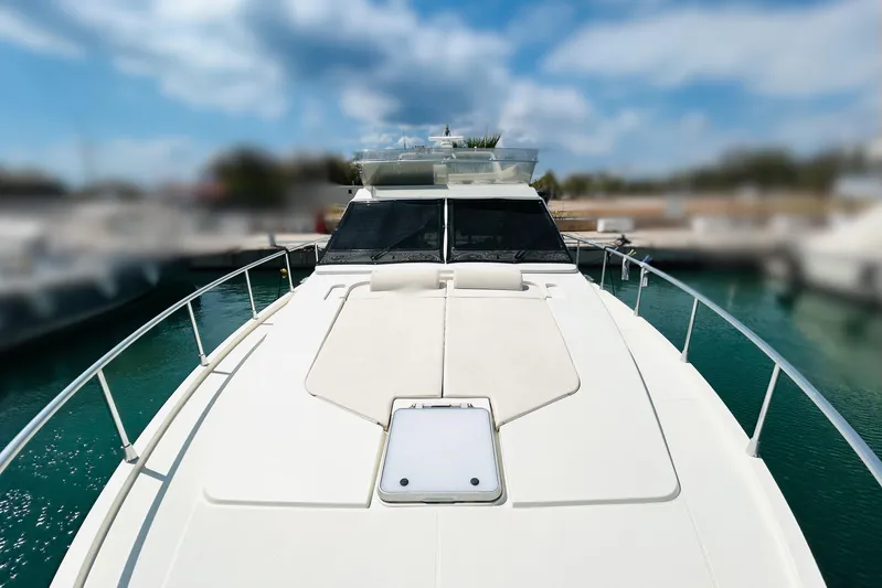  Yacht Photos Pics 1992 Ferretti Yachts 45 Altura on water, showcasing sleek deck design and clear skies.