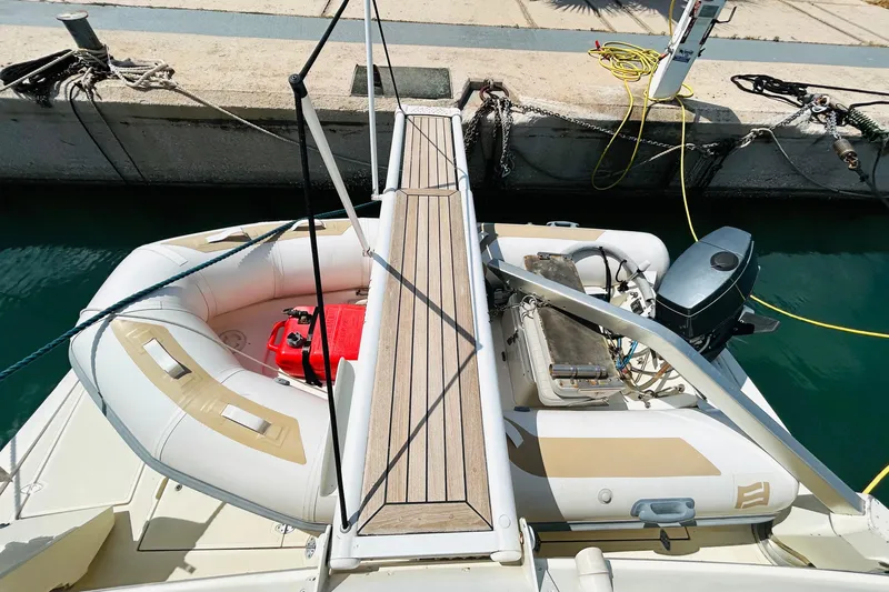  Yacht Photos Pics 1992 Ferretti Yachts 45 Altura with inflatable dinghy and outboard motor at dock.
