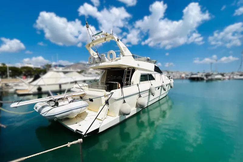  Yacht Photos Pics 1992 Ferretti Yachts 45 Altura docked in a sunny marina, clear skies above.