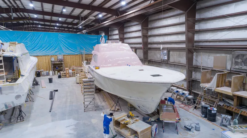 Chadwick 63 Yacht Photos Pics 2024 Custom Carolina 63 yacht under construction in a large indoor facility.