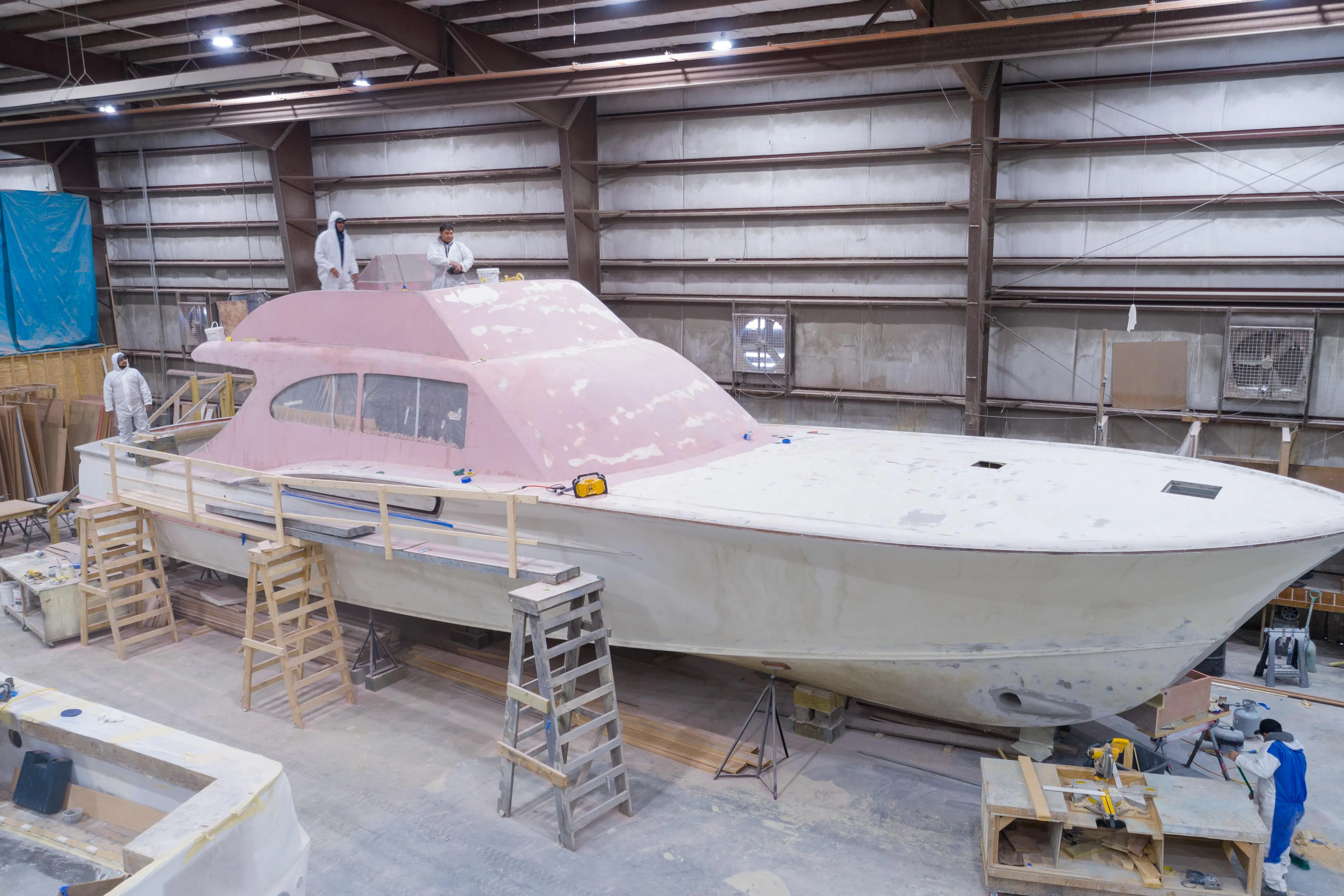 2024 Custom Carolina 63 yacht under construction in a workshop, showcasing skilled craftsmanship.