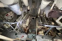 Engine room of a 1970 Custom Bootswerft Burmester 24 boat, showing machinery and pipes.