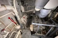 Engine room of a 1970 Custom Bootswerft Burmester 24 boat, featuring pipes and machinery.