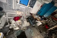 Engine room of a 1970 Custom Bootswerft Burmester 24 boat with machinery and tools.