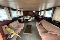 Interior of 1970 Custom Bootswerft Burmester 24 boat with sofas, table, and windows.