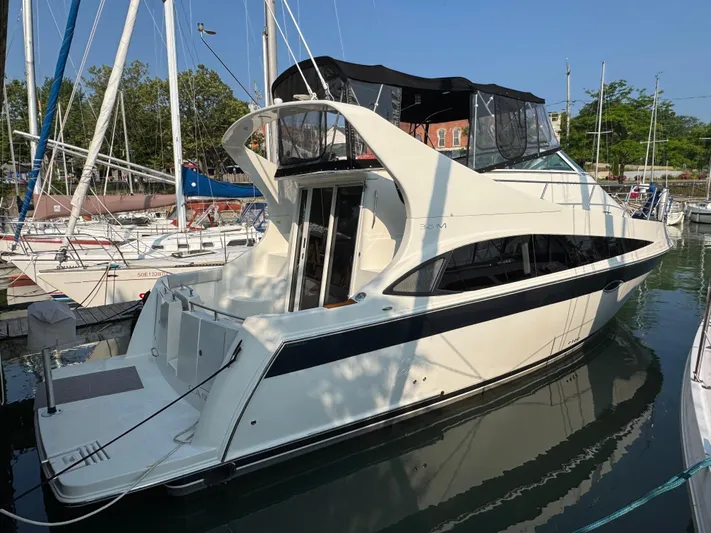  Yacht Photos Pics 2008 Carver 36 Mariner yacht docked in a marina, surrounded by sailboats.