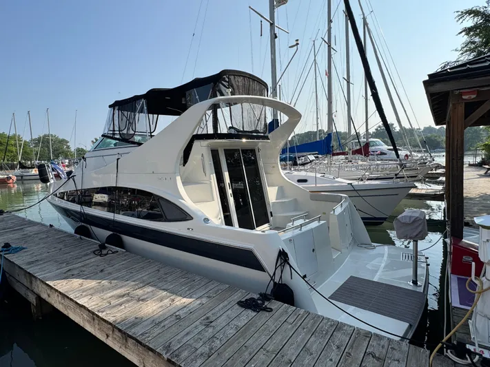  Yacht Photos Pics 2008 Carver 36 Mariner yacht docked at a marina with sailboats in the background.
