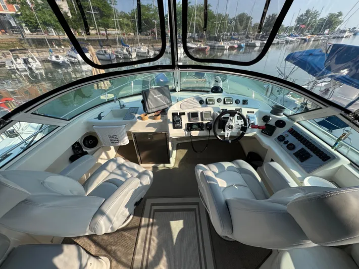  Yacht Photos Pics 2008 Carver 36 Mariner cockpit with modern controls and comfortable seating in a marina setting.