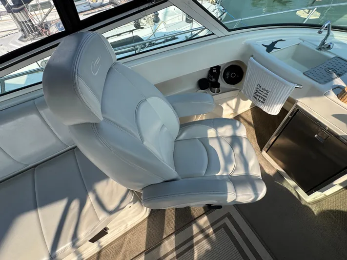  Yacht Photos Pics Captain's chair on 2008 Carver 36 Mariner yacht, featuring sleek white upholstery and helm station.