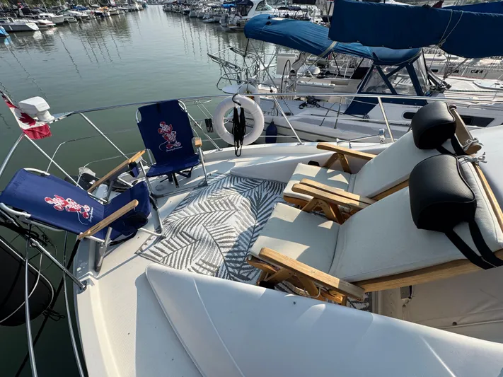  Yacht Photos Pics 2008 Carver 36 Mariner yacht deck with chairs and patterned rug, docked at marina.