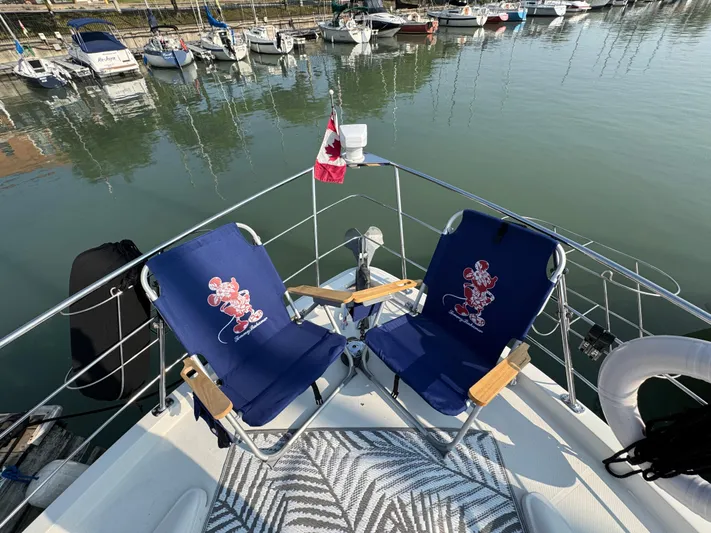  Yacht Photos Pics 2008 Carver 36 Mariner with blue chairs and Canadian flag at marina.