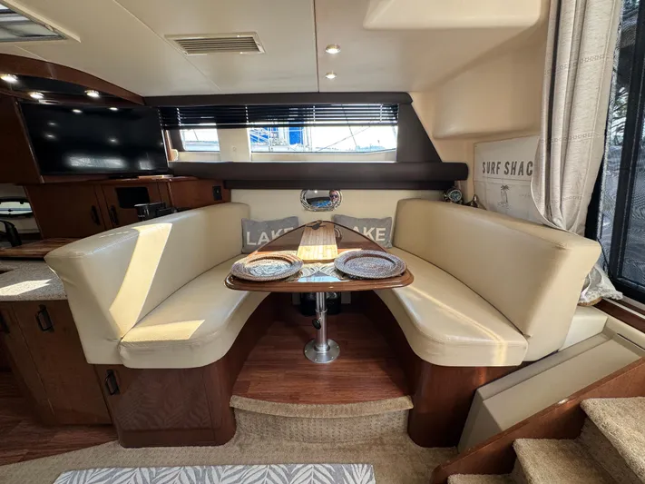  Yacht Photos Pics 2008 Carver 36 Mariner interior with cozy dining area, beige seating, and wooden table.