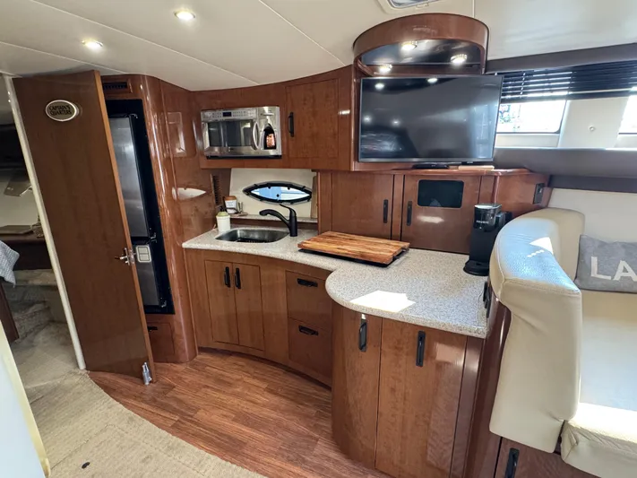  Yacht Photos Pics 2008 Carver 36 Mariner yacht interior with kitchen, TV, and seating area.