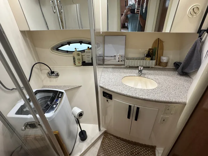  Yacht Photos Pics 2008 Carver 36 Mariner bathroom with sink, washing machine, and storage cabinets.