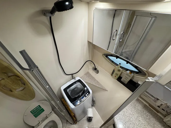  Yacht Photos Pics 2008 Carver 36 Mariner bathroom with washer, shower, and storage cabinets.