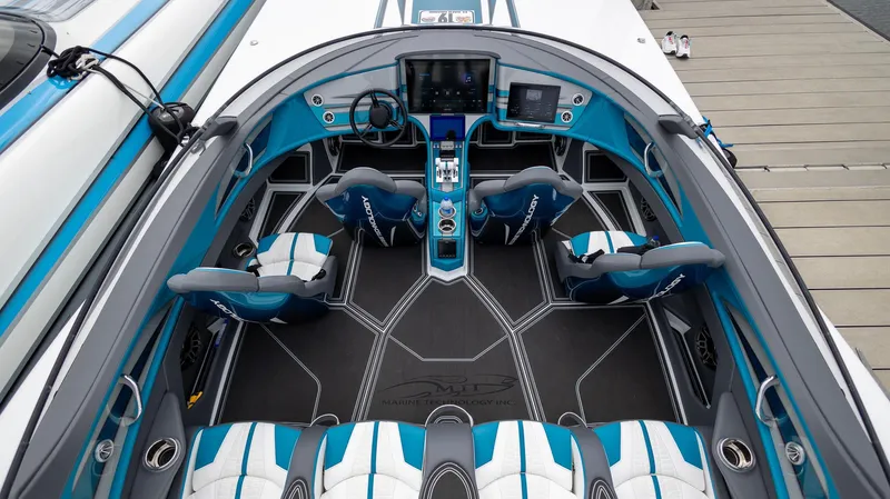  Yacht Photos Pics 2024 MTI 440X boat interior with modern design, blue and white seating, and advanced dashboard.