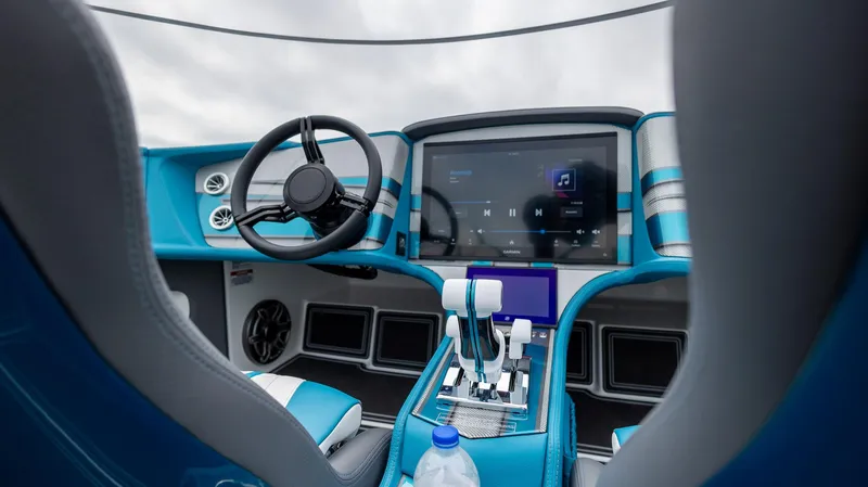  Yacht Photos Pics 2024 MTI 440X boat cockpit with modern steering, touchscreen, and blue accents.