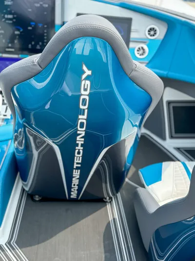  Yacht Photos Pics 2024 MTI 440X boat interior with blue and gray seating, featuring advanced marine technology.