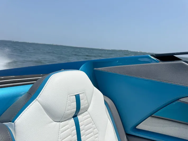  Yacht Photos Pics 2024 MTI 440X boat interior with blue and white seating, ocean view.