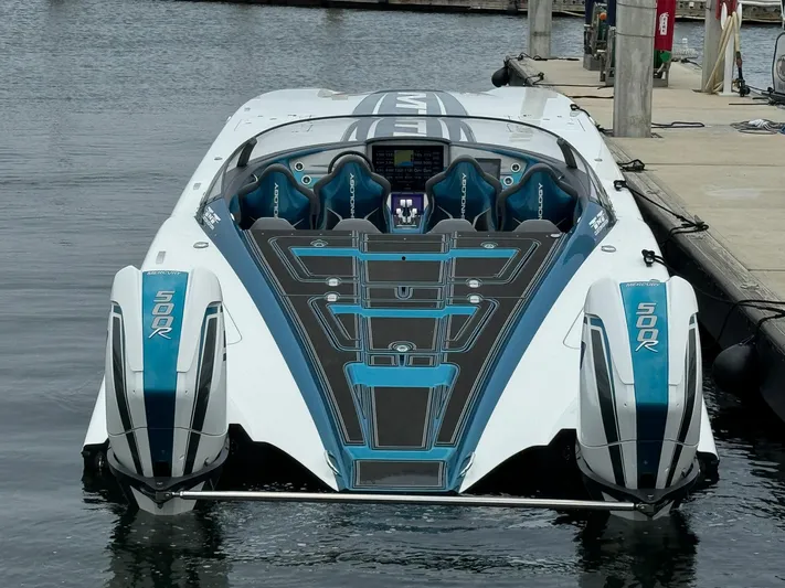  Yacht Photos Pics 2024 MTI 440X speedboat docked, featuring sleek design and modern seating.