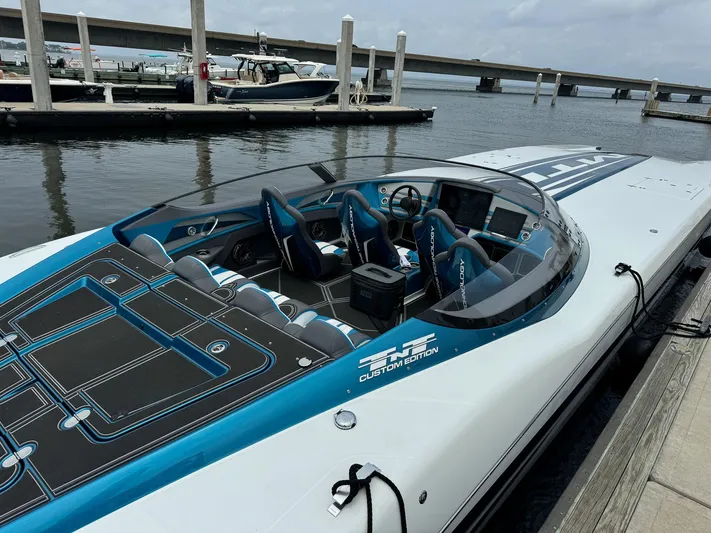  Yacht Photos Pics 2024 MTI 440X speedboat docked, featuring sleek design and modern cockpit.