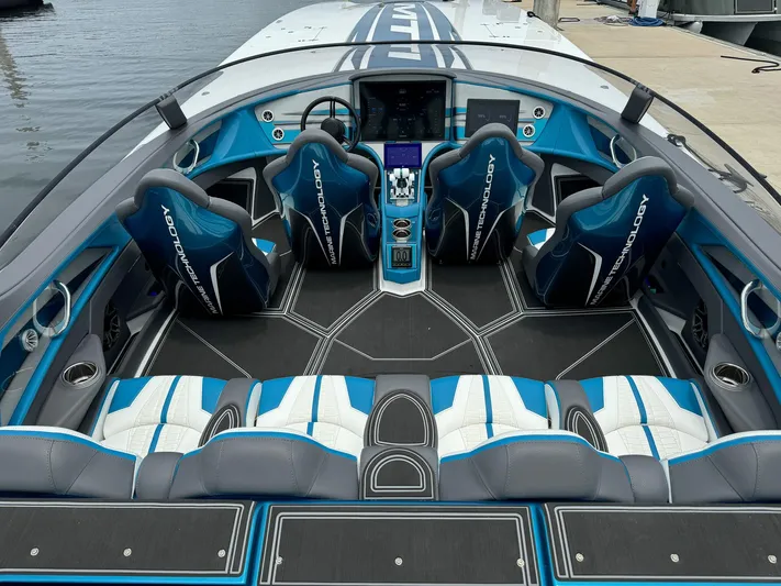  Yacht Photos Pics 2024 MTI 440X boat interior with blue and white seating, advanced dashboard, and sleek design.