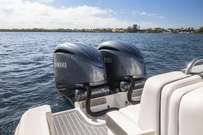  Yacht Photos Pics 2022 Chaparral 300 OSX with twin Yamaha outboard engines on a sunny day.