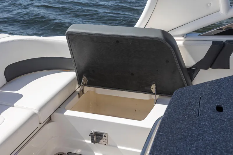  Yacht Photos Pics 2022 Chaparral 300 OSX boat with open storage compartment on deck.