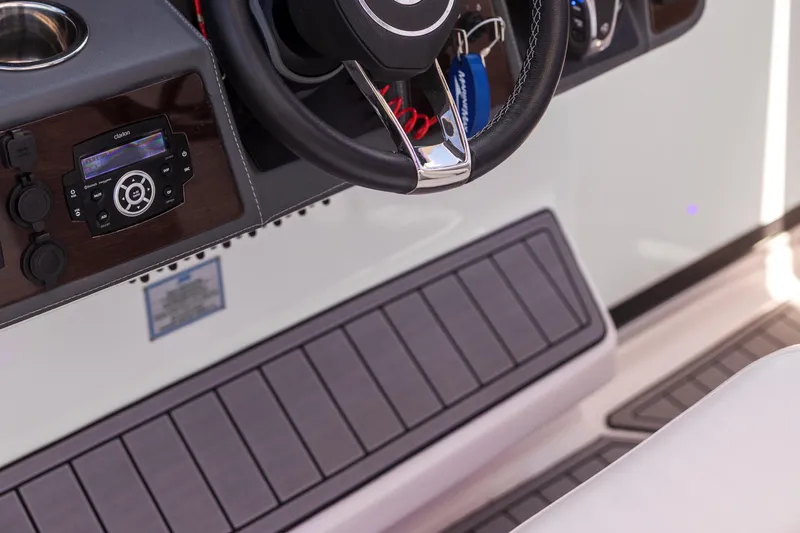  Yacht Photos Pics 2022 Chaparral 300 OSX boat dashboard with steering wheel and control panel.