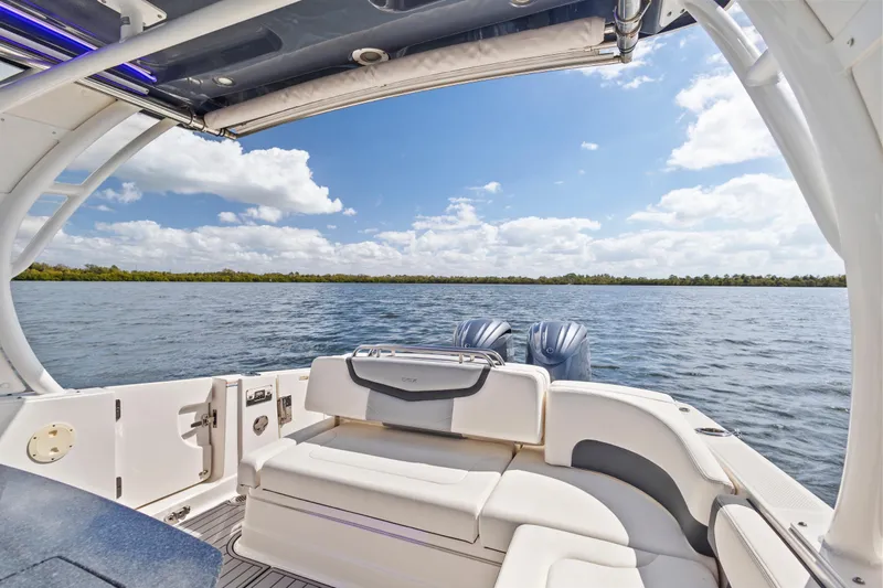  Yacht Photos Pics 2022 Chaparral 300 OSX boat interior with scenic water view and clear sky.