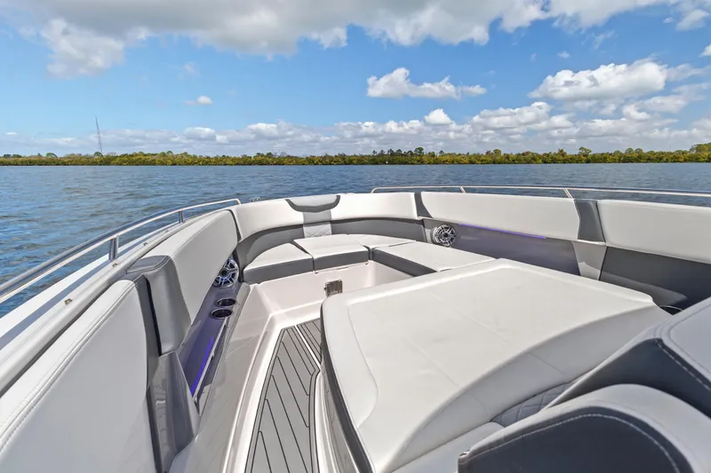  Yacht Photos Pics 2022 Chaparral 300 OSX boat interior with luxurious seating on a sunny day.