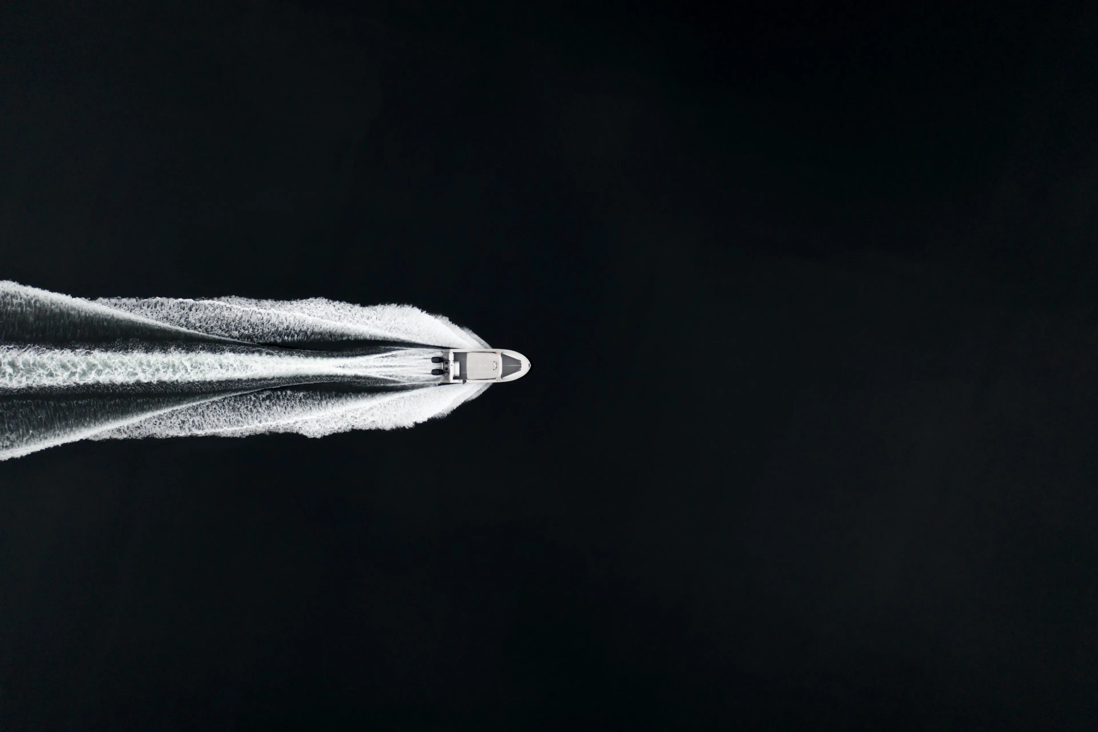 Aerial view of 2025 Jasper Marine Defender 22 speedboat cutting through water.