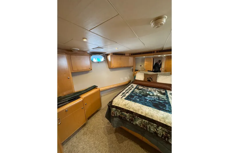 Evening Star Yacht Photos Pics Cozy cabin interior of 2003 Cape Horn Trawler with bed and wooden storage cabinets.