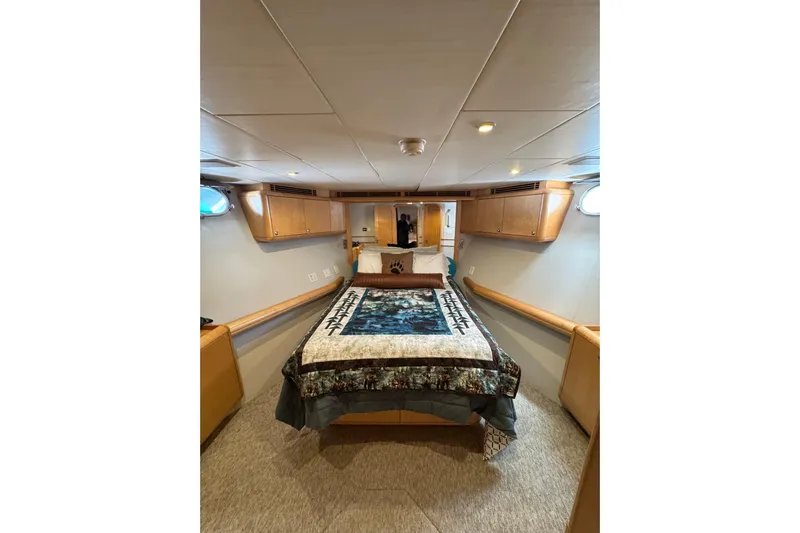 Evening Star Yacht Photos Pics Cozy cabin interior of 2003 Cape Horn Trawler with bed and wooden cabinetry.