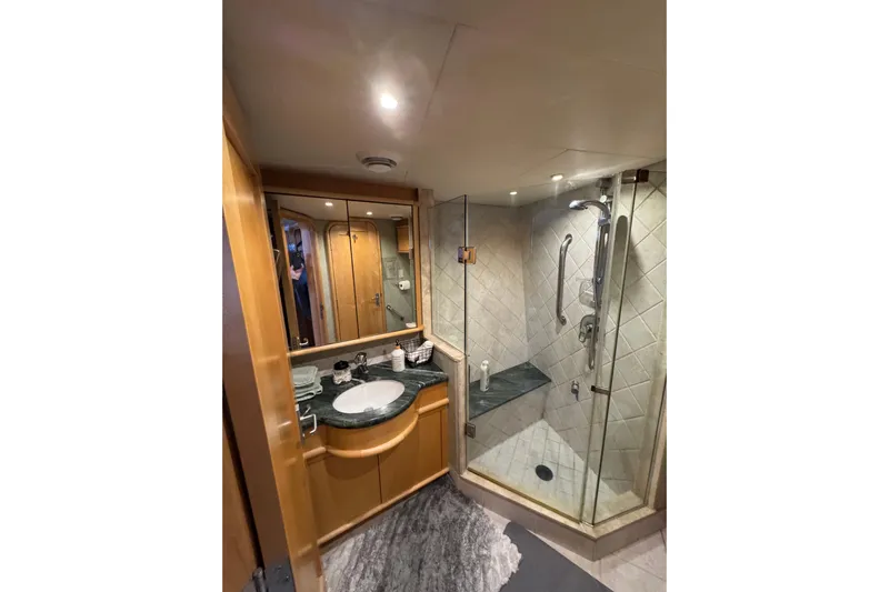 Evening Star Yacht Photos Pics Luxurious bathroom in 2003 Cape Horn Trawler with glass shower and elegant vanity.