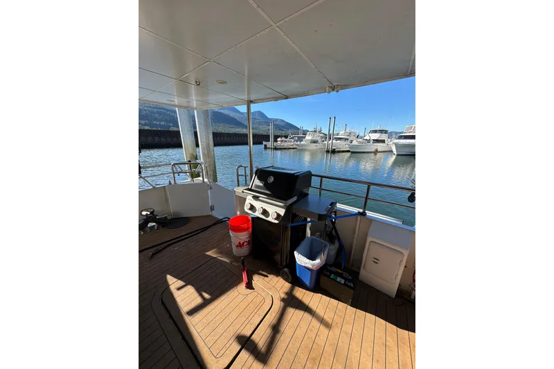 Evening Star Yacht Photos Pics 2003 Cape Horn Trawler deck with grill, docked at marina, scenic mountain view.