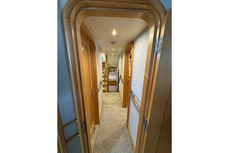Evening Star Yacht Photos Pics Interior hallway of 2003 Cape Horn Trawler with wooden doors and carpeted floor.